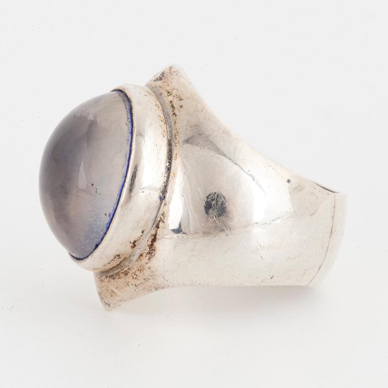 A Rey Urban sterlingsilver ring with cabochon-cut blue stone.