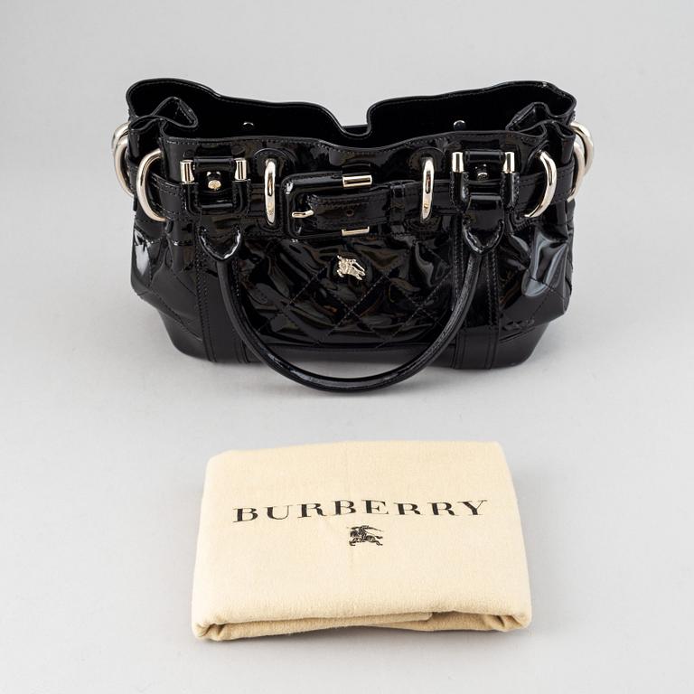 Burberry, a patent leather handbag.