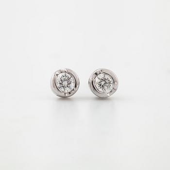 A pair of brilliant cut diamond earrings.