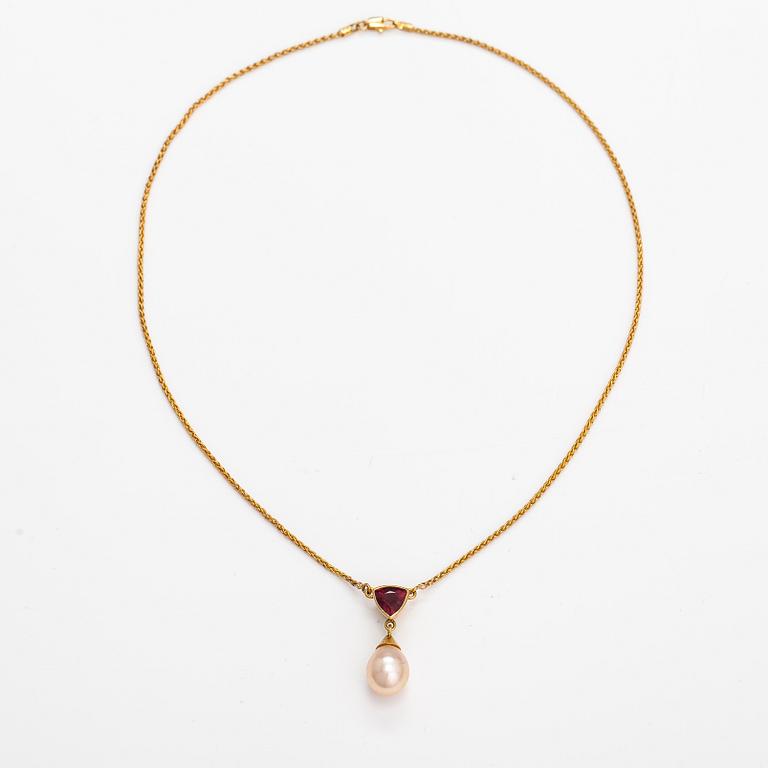 A 14K gold necklace with a tourmaline and cultured pearl.