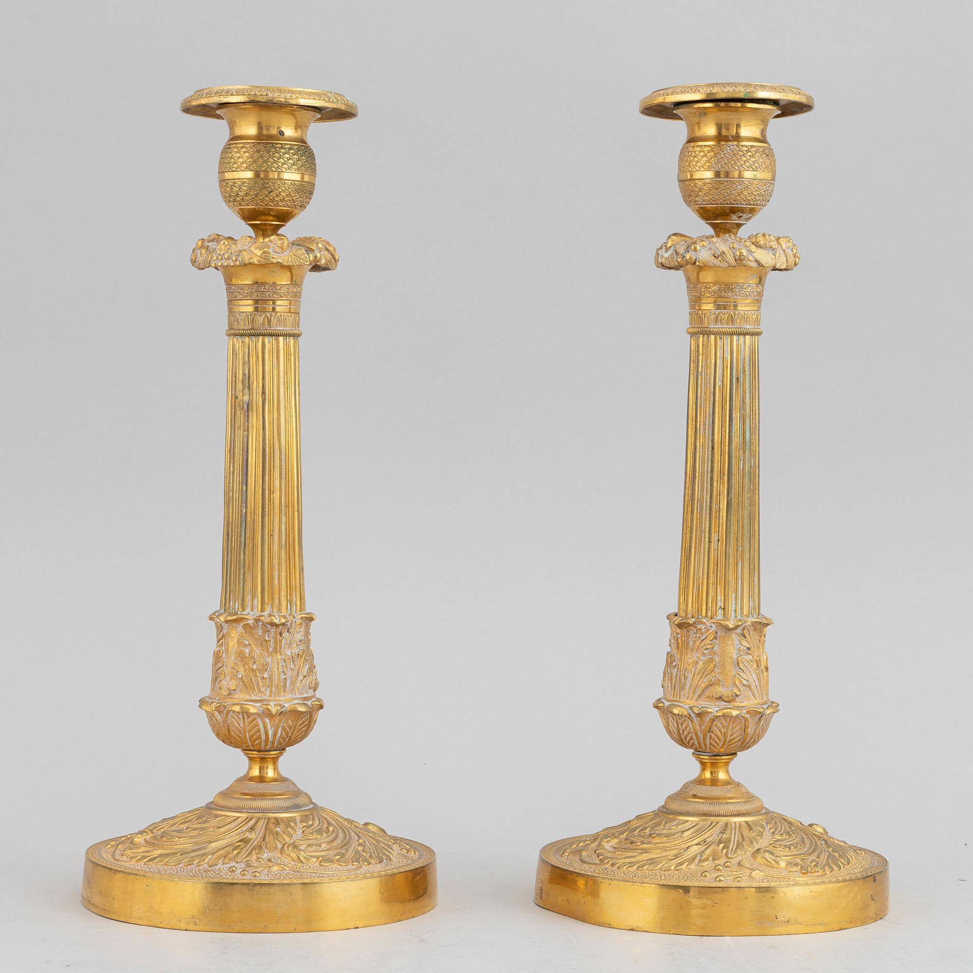 A circa 1900 empire style brass candlesticks.