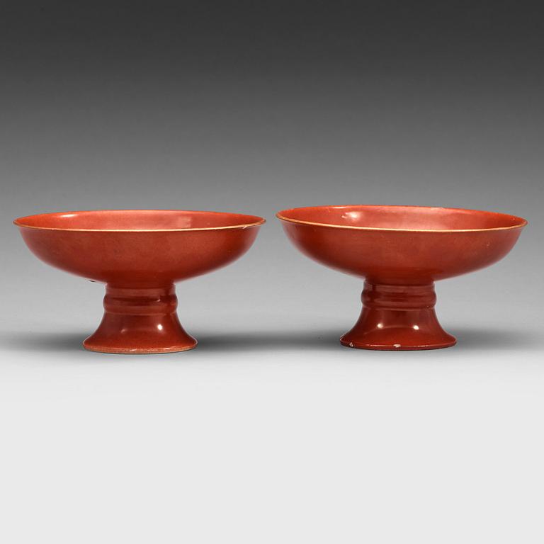 A pair of red glazed tazzas, Qing dynasty with Qianlong sealmark in underglaze blue.