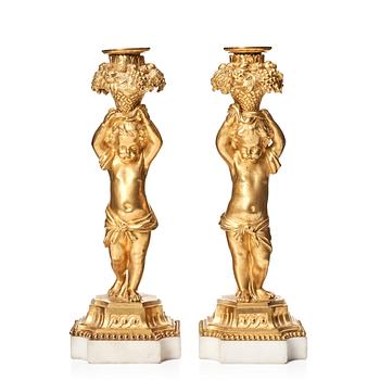 130. A pair of Louis XVI-style 19th century gilt bronze and marble candlesticks.