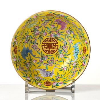 A yellow glazed 'nine bats and peaches' bowl, late Qing dynasty with Guangxu mark.