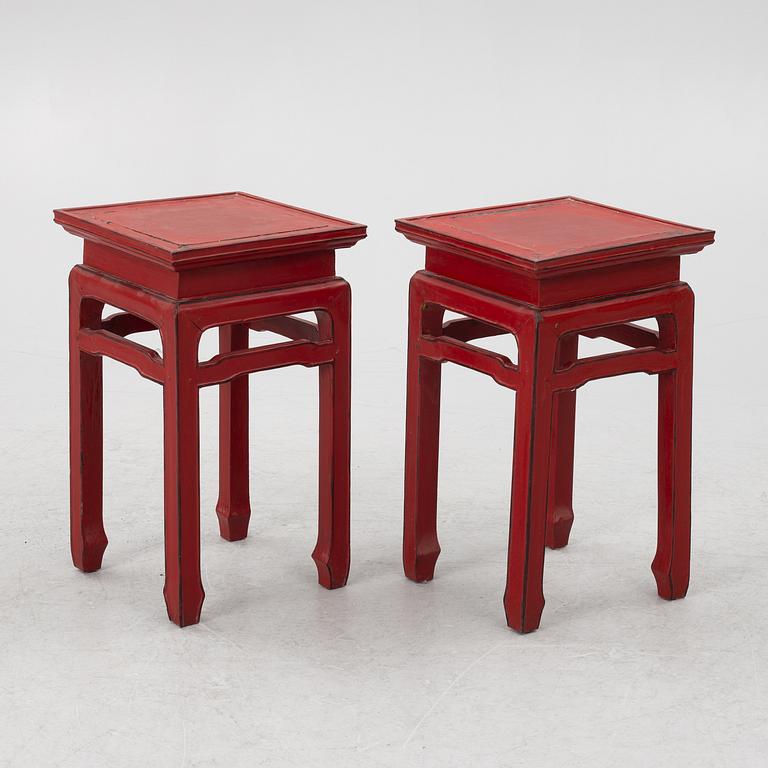 A pair of red Chinese small tables, 20th century.