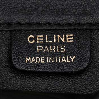 CÉLINE, a black patent leather bag.