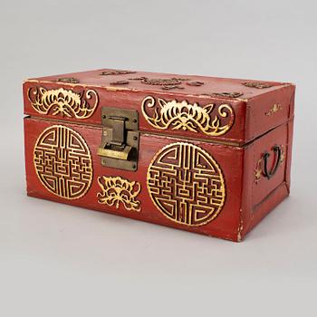 A red and gilt lacquered 'marriage' chest, late Qing dynasty.