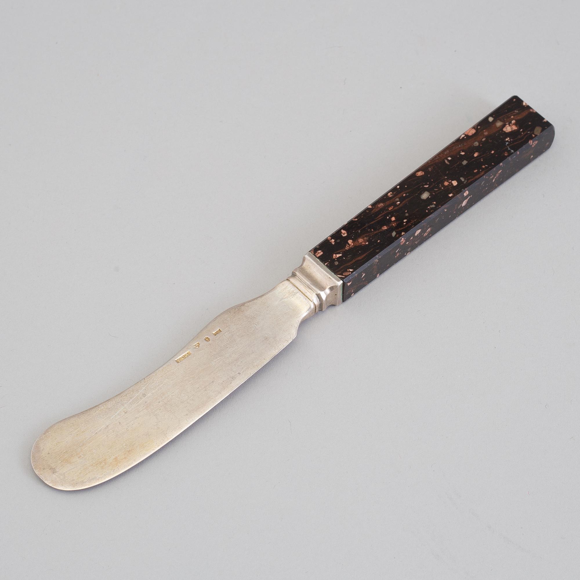 A silver butterknife with porphyry shaft, dated 1853.