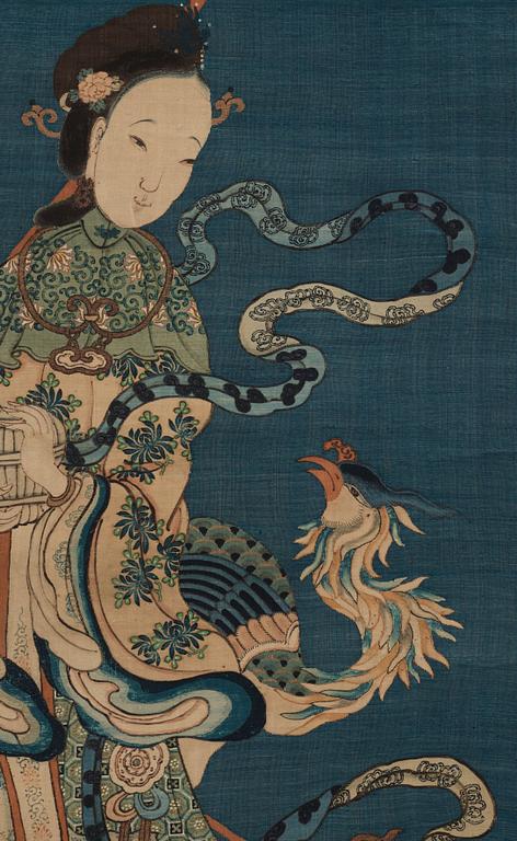 A blue ground kesi hanging scroll, depicting Xi Wangmu with a Jade girl and Phoenix, Qing dynasty, 19th Century.