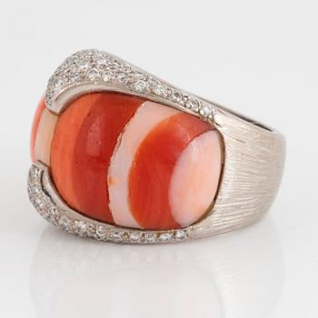 A Paul Binder ring in 18K white gold set with coral and round brillliant-cut diamonds.