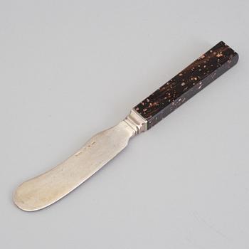 A silver butterknife with porphyry shaft, dated 1853.