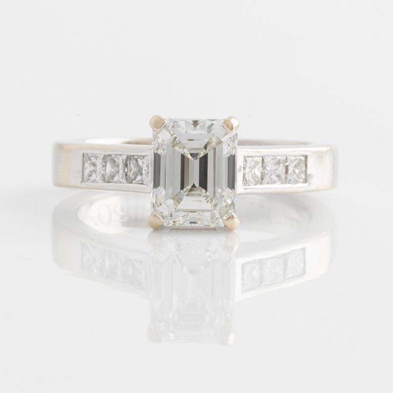 An 18K white gold ring set with an emerald-cut diamond.