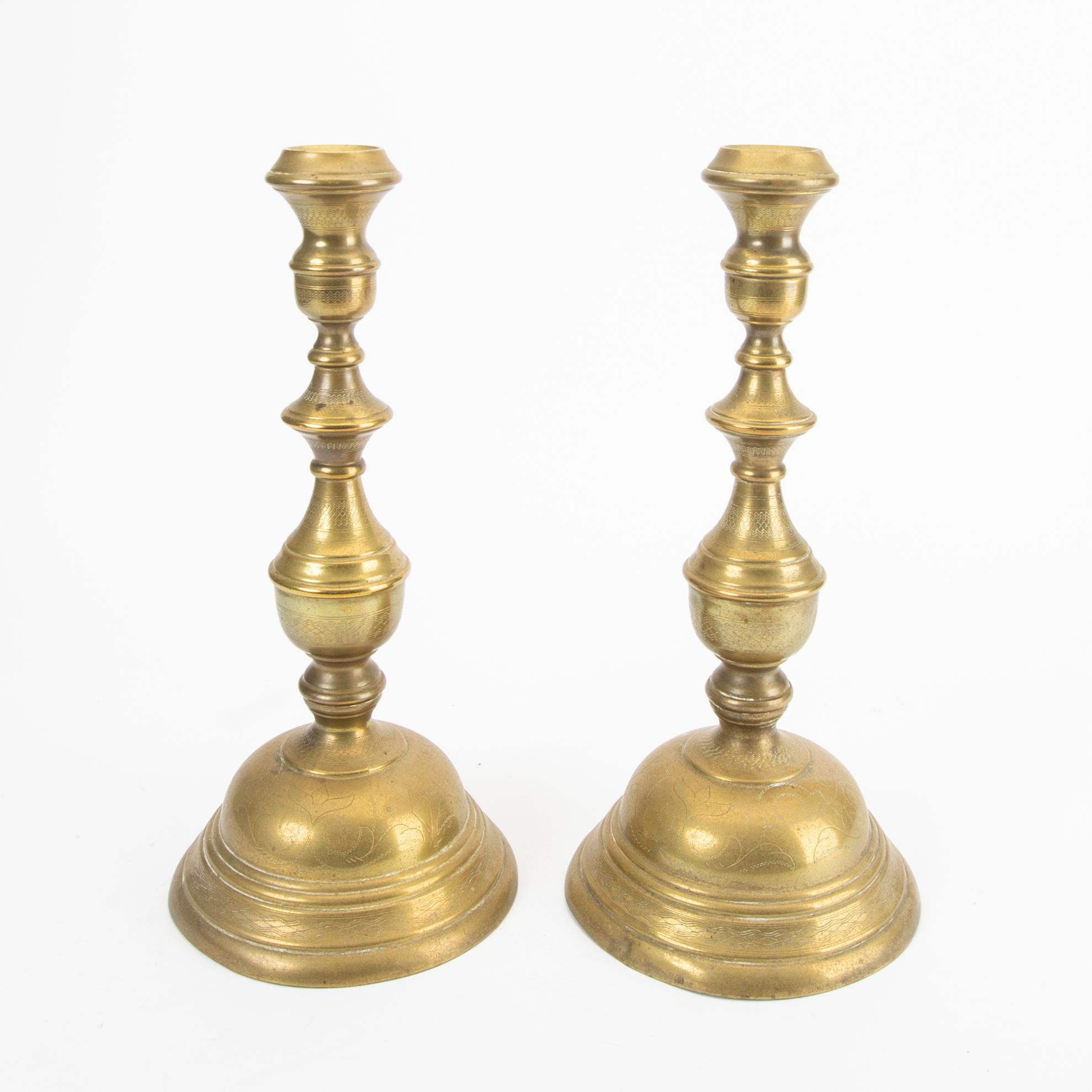 A pair of late 19th century brass candle sticks.