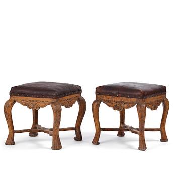 195. A pair of carved stools in the manner of Jonas Granberg, Jämtland, Sweden, mid 18th century.