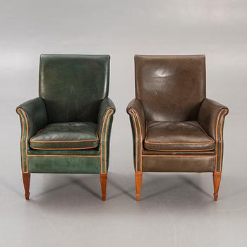 A set of two leather armchairs lat er part of the 20th century.