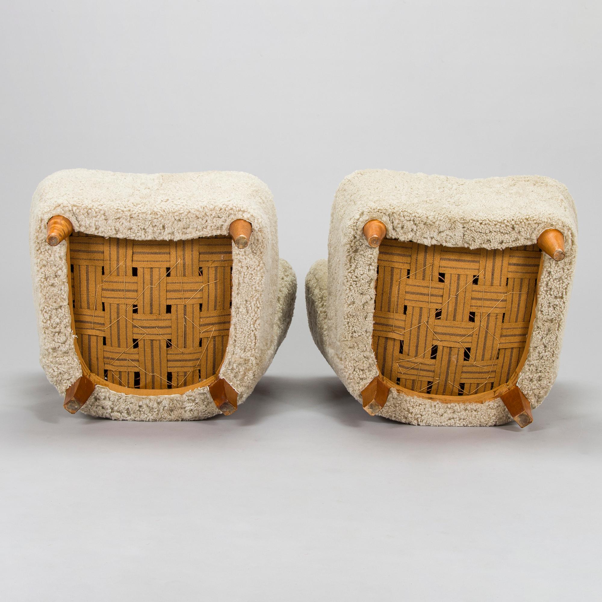 A pair of mid-20th century armchairs in sheepskin.