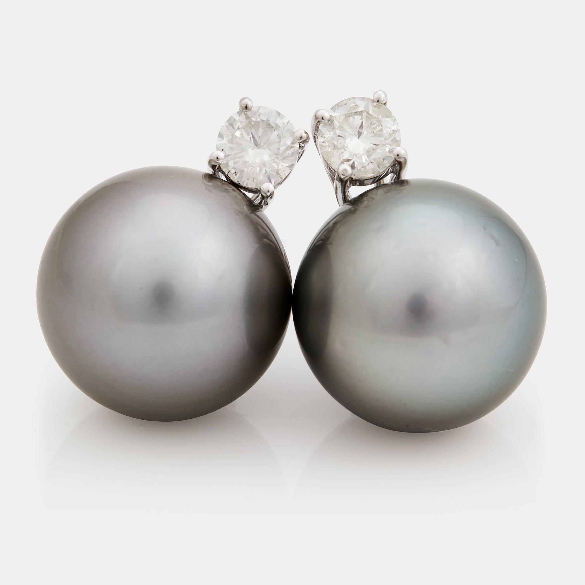 A pair of cultured Tahiti pearl and brilliant cut diamond earrings.