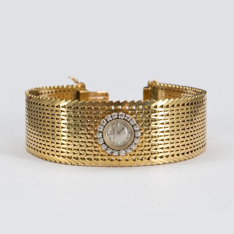 DAMARMBANDSUR, 18 k guld med krans av briljantslipade diamanter ca 0,20 ct, Jaeger le Coultre. Vikt ca 72,5 g.