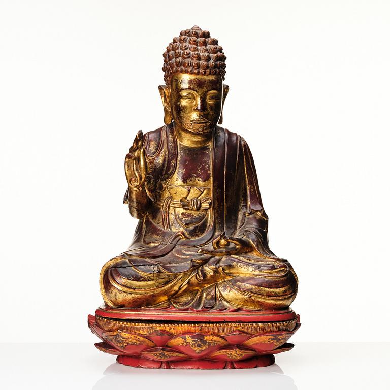 A large gilt and lacquered figure of a seated buddha, Qing dynasty, 19th Century.