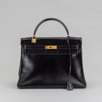 Hermès,a black leather 'Kelly 32' handbag, 1975.