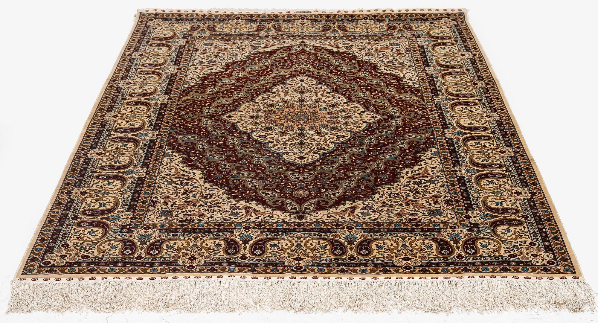 A semi-antique silk Hereke rug, West Anatolia, c. 180 x 121 cm.