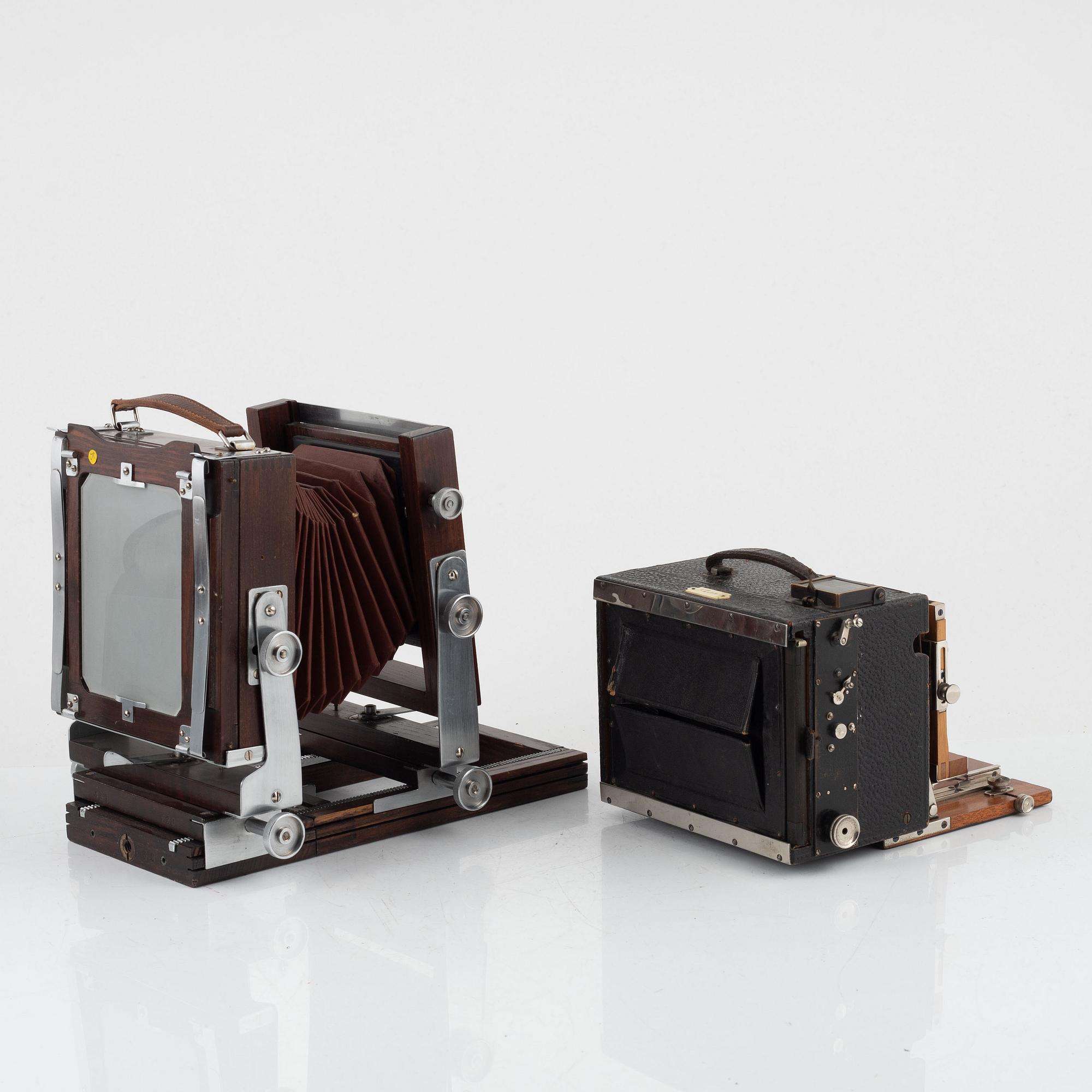 Two box cameras with accessories and a handheld stereo viewer.