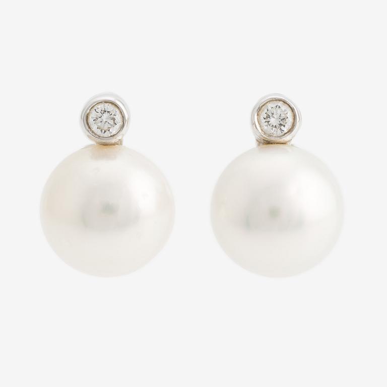 A pair of 18K gold earrings with cultured pearls and round brilliant-cut diamonds.