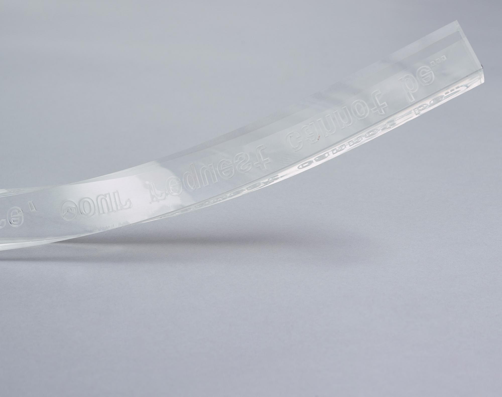 Yngve Holen, executed in 2014. Engraved acrylic glass, cable, lock, trainer, snap bracelet.