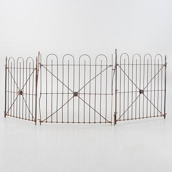 A pair of iron garden gates and a single gate from the early 20th century.