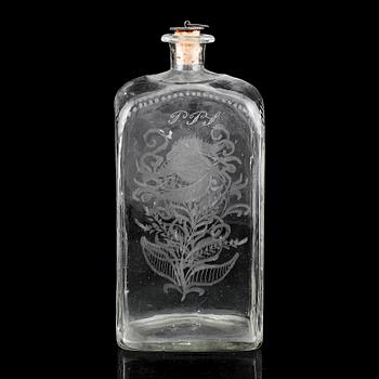A glass bottle and three vodka glasses, 19th Century.