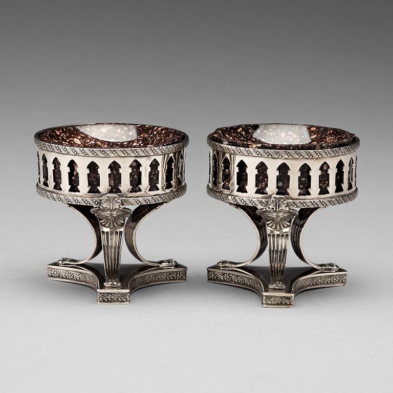 A pair of Swedish 19th century porphyry and silver salt-cellars, silver with mark of Gustaf Folcker, Stockholm 1823.