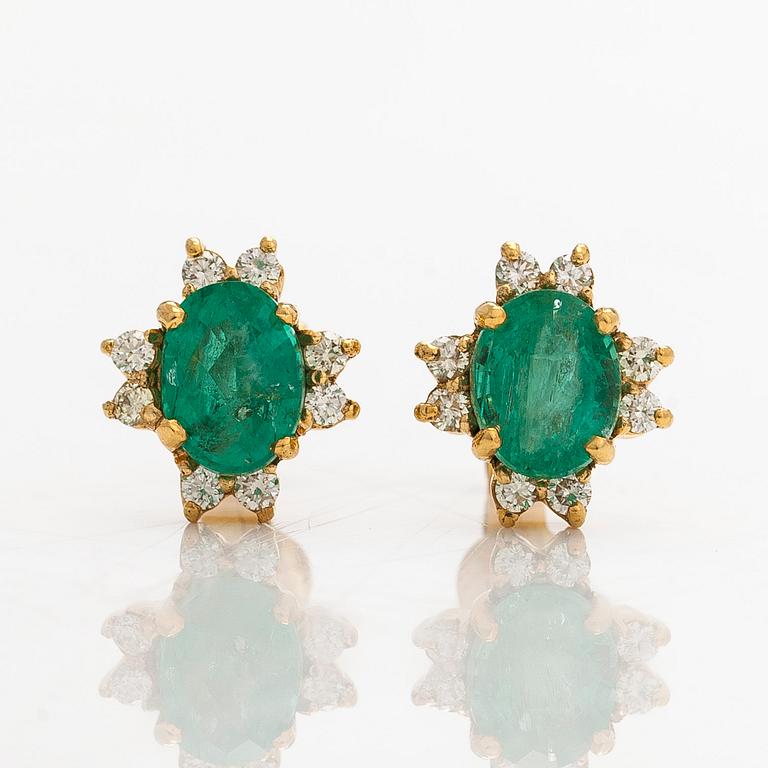 A pair of 14K gold earrings with faceted emeralds and diamonds.