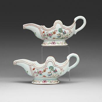 A pair of famille rose 'double peacock' sauce boats, Qing dynasty, Qianlong (1736-95).