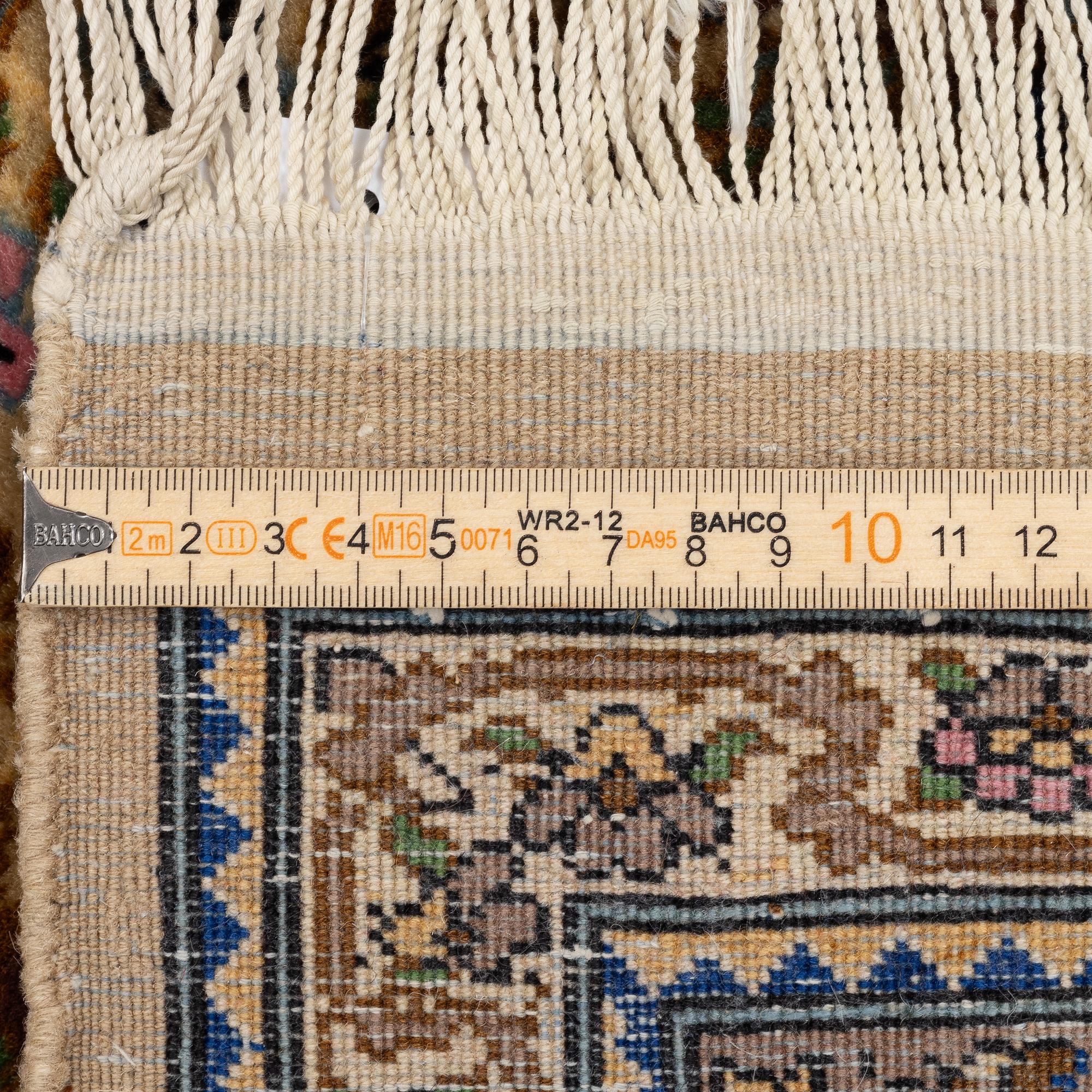 A Tabriz rug, a. 214 x 137 cm.