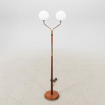 A mid 20th century teak and brass floor lamp.