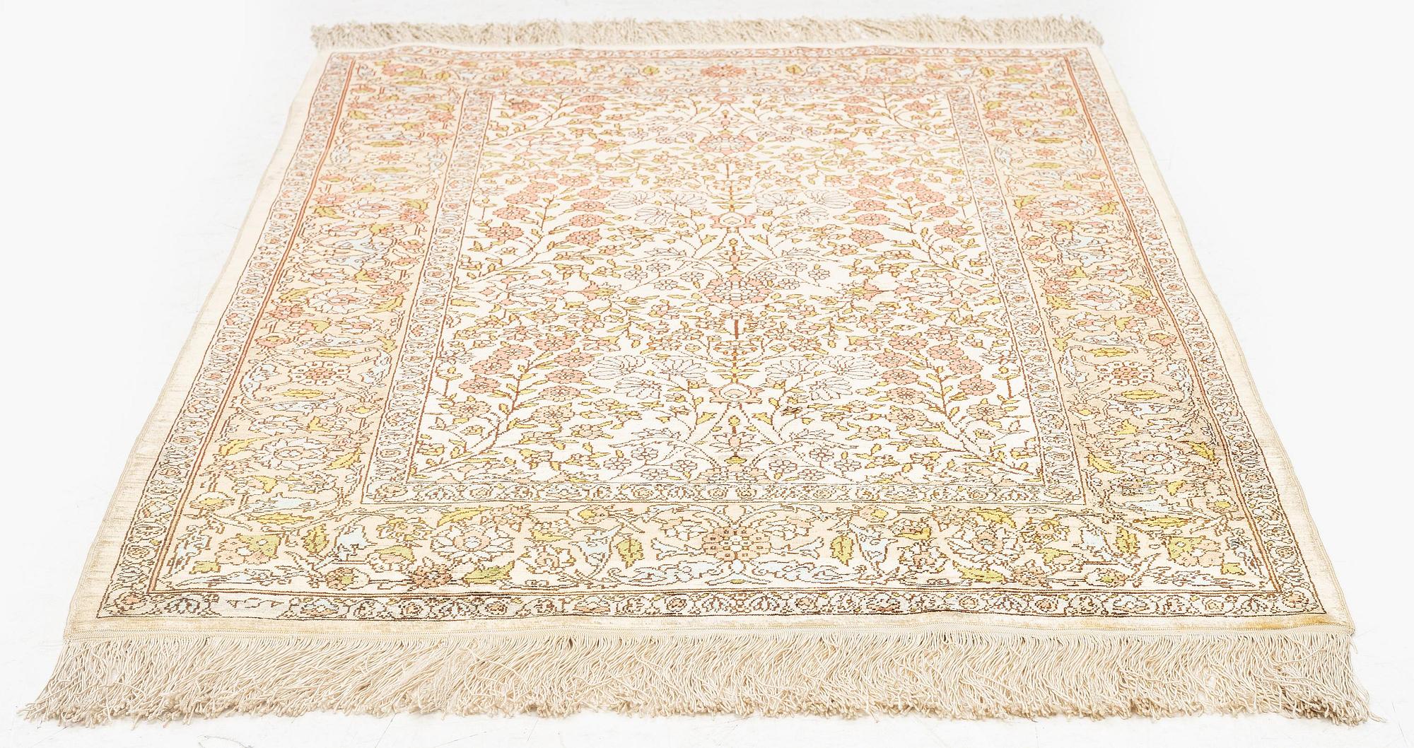 A silk Hereke rug, c. 112 x 74 cm.
