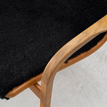 Yngve Ekström, a 'Lamino' armchair and sidetable, Swedese, Sweden, early 21st century.