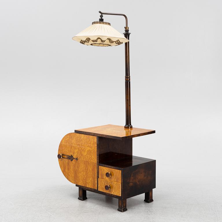 A 1930s sidetable with a lamp.