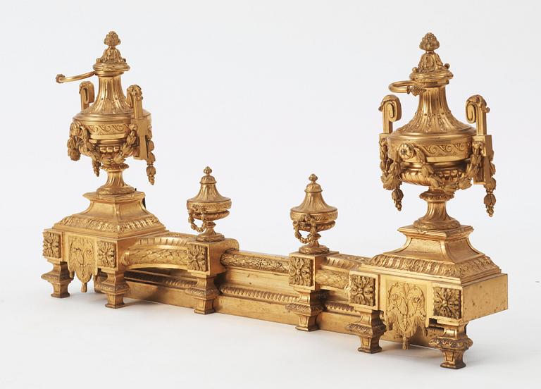 A pair of French Louis XVI-style 19th century gilt bronze fire dogs.