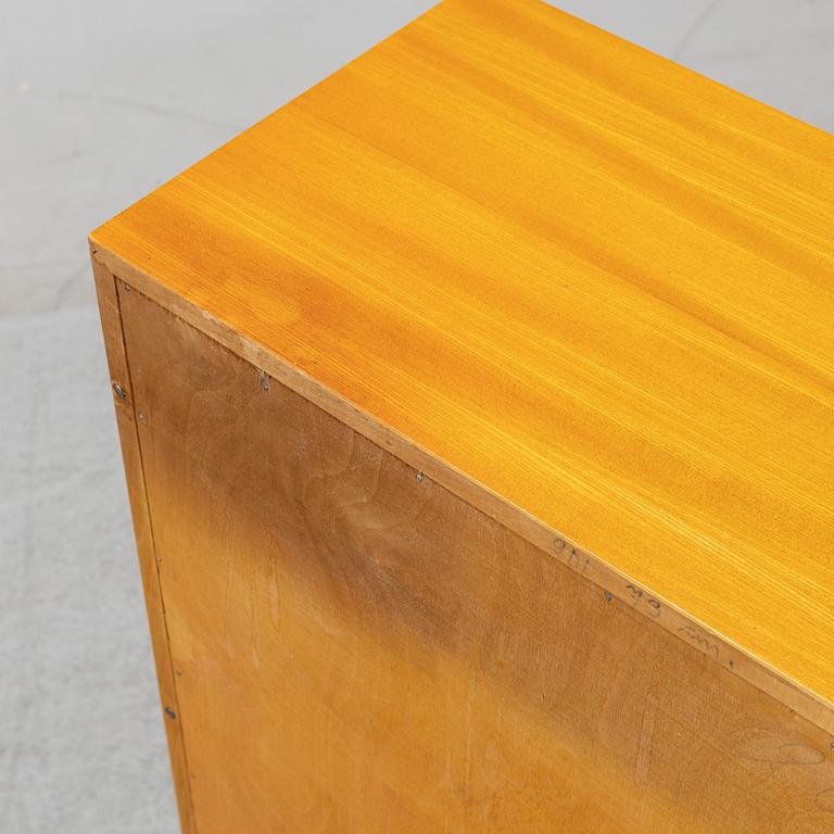 A three piece corner book case with a cabinet.