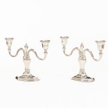 A pair of silver candelabras, with Swedish import marks, possibly mid20th century.