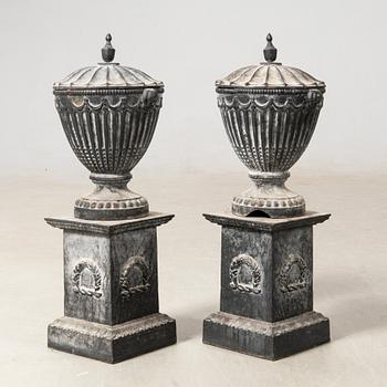 Garden urns, a pair with pedestals, 20th century, cast iron.