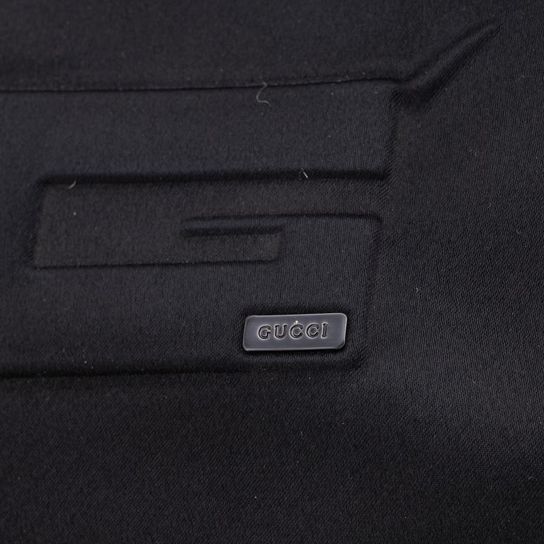 Gucci, a black satin handbag.