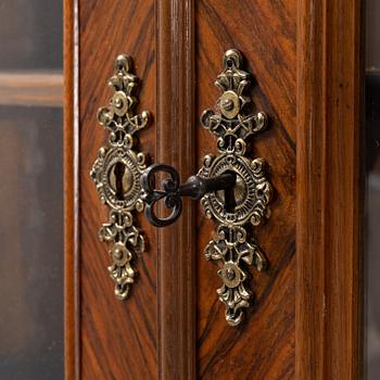 A walnut veneered book cabinet, second part of the 20th Century.