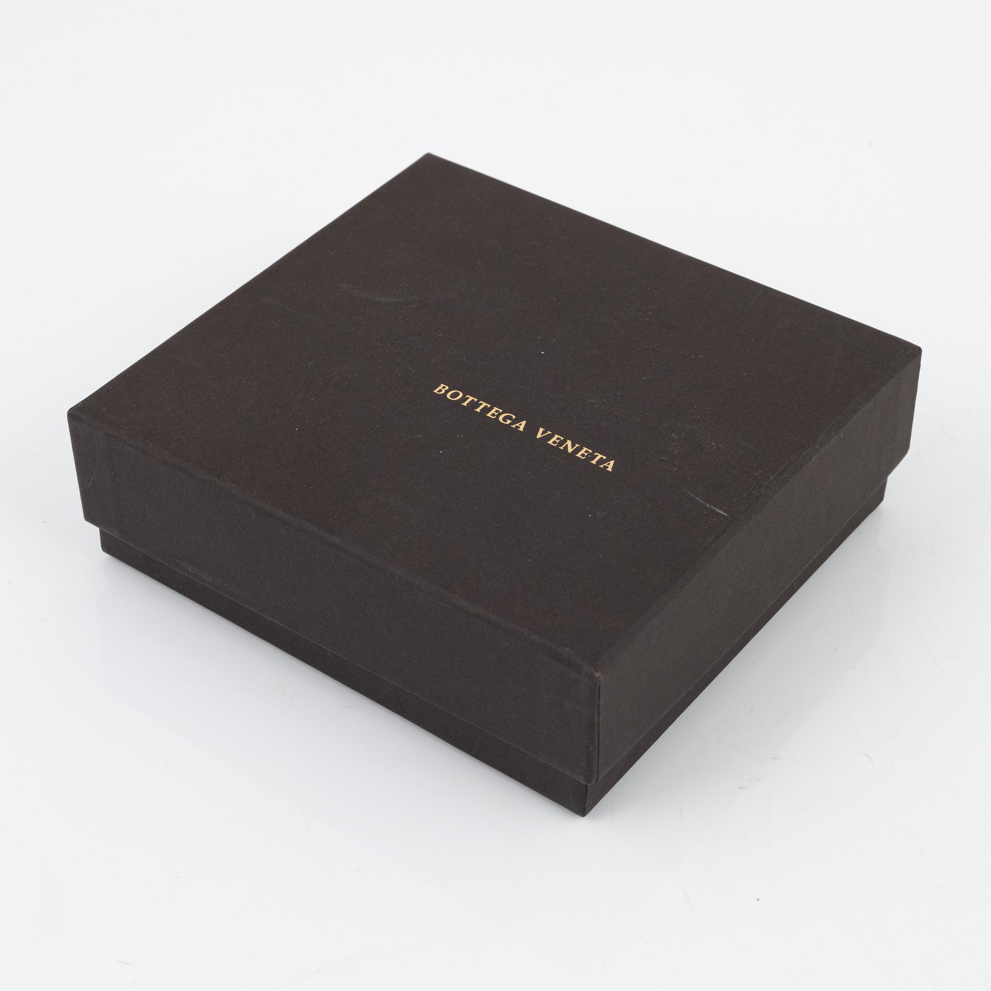 Bottega Veneta, a wallet and bracelet.
