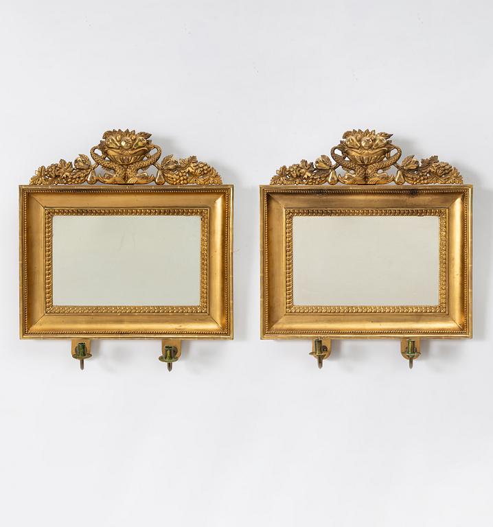A pair of Empire giltwood two-branch girandole mirrors, Sweden, first part 19th century.