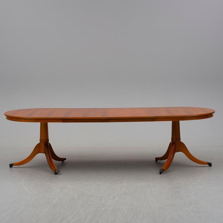 a late 20th century dining table with eight chairs.