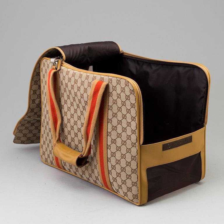 GUCCI, a monogram canvas dog bag.