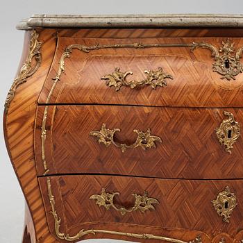 A rococo rosewood-veneered and ormolu-mounted commode by N. Korp (master 1763-1800).