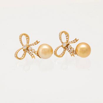 A pair of 18K gold earrings set with round brilliant-cut diamonds and cultured pearls.